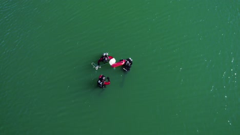 Three-divers-searching-for-an-object-in-a-lake-in-the-south-of-France