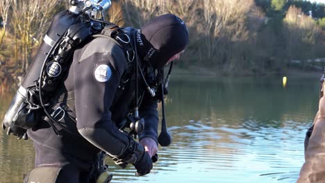 A-diver-out-of-the-water-puts-on-his-black-gloves