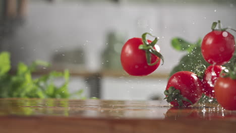 Slow-motion-of-red-cherry-tomatos-falling-on-wet-wooden-board-in-a-kitchen