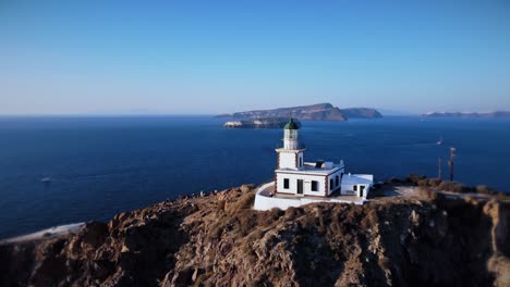 Santorini-Lighthouse-Circular-Orbit-Drone-Shot-During-Sunset