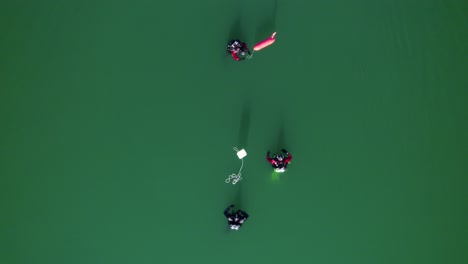 Divers-in-a-lake-searching-with-their-buoys-and-scuba-tank