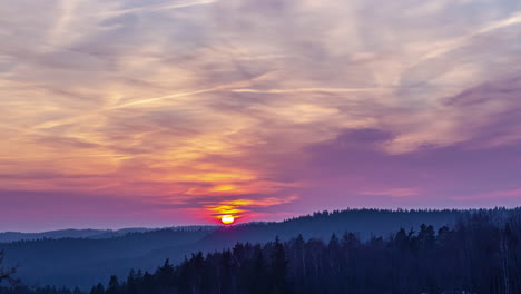 Colorful-sunset-over-a-mountain-forest-landscape---time-lapse