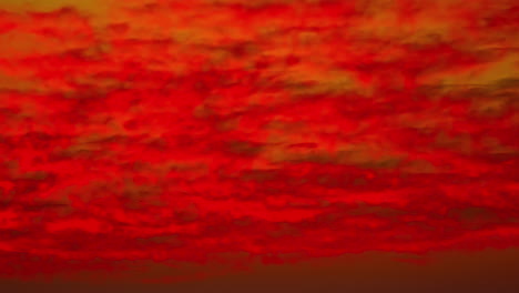 Timelapse-of-clouds-changing-colors-from-red-to-orange-during-sunrise