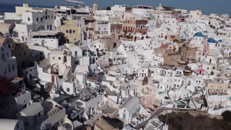 Aerial-panoramic-view-of-Oia-village-on-top-of-a-cliff-in-Santorini-Greece