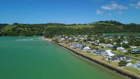 Aerial-footage-of-beach-side-town-at-high-tide-with-beach-front-properties-having-water-on-their-doorstep