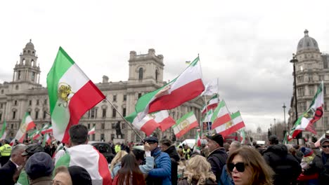 27-February-2023---Iran-Flags-Being-Held-And-Waved-By-British-Iranians-Protesting-Regime-Change-And-Rights-For-Women-In-Iran