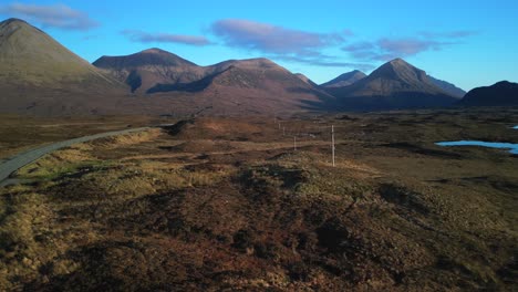 Fast-rise-up-over-winter-highland-landscape-towards-Red-Cuillin-mountains-on-Isle-of-Skye-Scotland