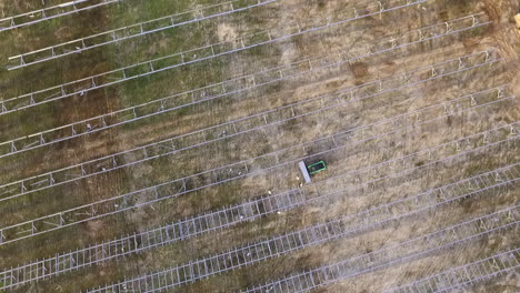 Drone-shot-of-a-solar-field-being-constructed,-downward-angle-and-rotating