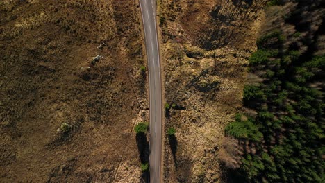 Top-down-view-of-highland-road-with-truck-next-to-Loch-Loyne-in-Scottish-Highlands