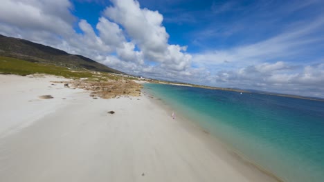 FPV-drone-in-Errisbeg-beach,-the-color-of-that-water-is-simply-breathtaking-beauty
