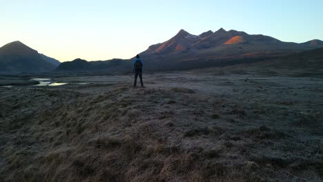 Slow-pan-to-Black-Cuillin-at-dawn-with-hiker-on-Isle-of-Skye-Scotland