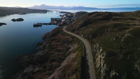 Pan-across-revealing-Kyle-of-Lochalsh-with-Skye-bridge-and-traffic-in-Scottish-Highlands