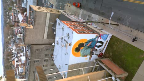 Aerial-drone-view-of-street-mural-on-the-side-of-a-building