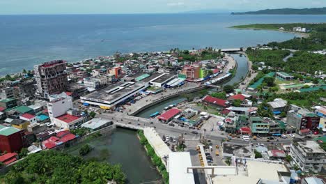 Rising-Aerial-View-of-Coastal-town-and-busy-streets-in-Virac,-Catanduanes,-Philippines