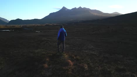 Excursionista-Y-Cordilleras-Montañosas-Iluminadas-Por-El-Amanecer-De-Cuillin-Rojo-Y-Negro-En-La-Isla-De-Skye,-Escocia