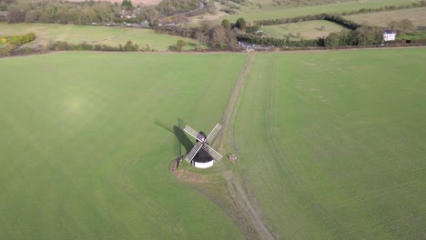 Aerial-view-orbiting-Pitstone-windmill-landmark-high-above-idyllic-Buckinghamshire-rural-agricultural-field