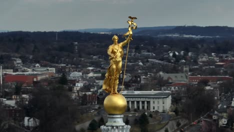 Aerial-orbit-around-Miss-Penn,-statue-on-top-of-rotunda-of-Harrisburg-capitol-building