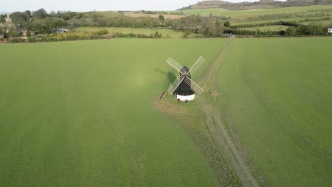 Establishing-aerial-view-rising-from-Pitstone-windmill-over-Buckinghamshire-National-trust-countryside-farmland-at-sunrise
