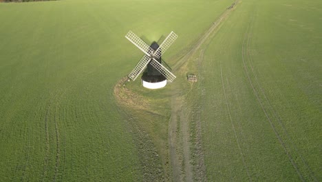Rising-aerial-view-of-Pitstone-windmill-landmark-on-picturesque-Buckinghamshire-rural-countryside