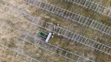 Drone-shot-of-a-solar-field-being-constructed,-downward-angle