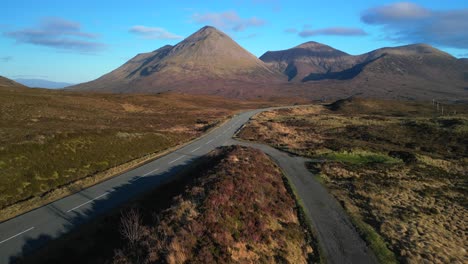 Rise-up-over-highland-road-revealing-Red-Cuillin-mountains-on-Isle-of-Skye-Scotland