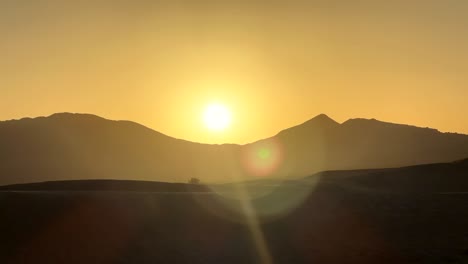 Timelapse-sun-rising-over-mountain-peaks-in-Sahara-desert-in-Morocco