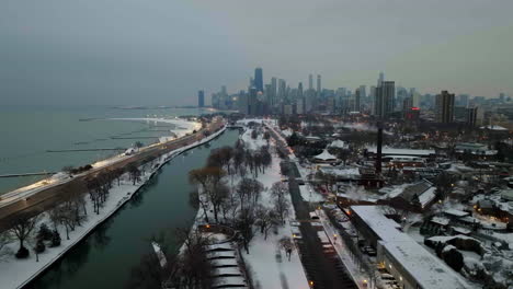 Aerial-view-over-the-South-Lagoon-and-the-US-hwy-41,-winter-evening-in-Chicago,-USA---tracking,-drone-shot