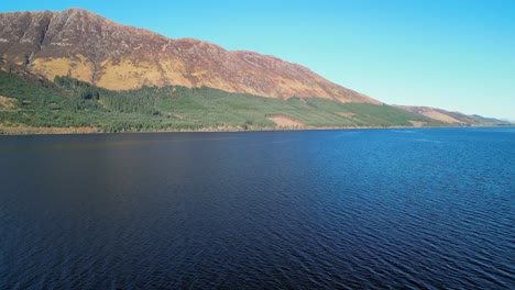 Rise-up-and-right-pan-over-dark-lake-of-Loch-Lochy-Scottish-Highlands