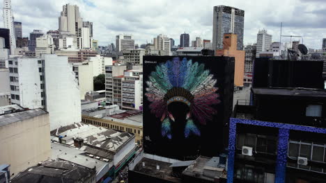 Aerial-view-in-front-the-XAMÃ-DO-AMOR-artwork-mural-at-Galeria-page,-in-Sao-paulo,-Brazil