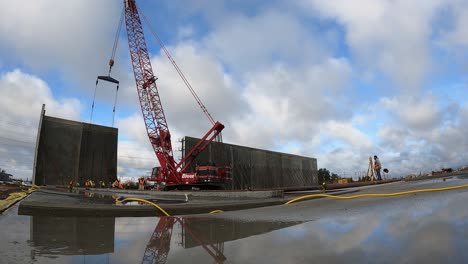 Concrete-wall-being-lifted-into-place-by-a-crane-for-commercial-warehouse
