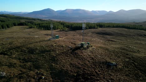 Slow-pan-of-communications-towers-with-distant-mountains-near-Loch-Loyne-Scottish-Highlands