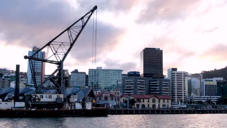 People-walking-along-the-waterfront-harbour-with-landscape-view-of-capital-city-Wellington-in-New-Zealand-Aotearoa