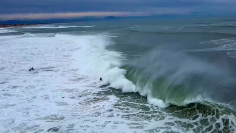 Surfer-gets-Towed-into-a-Large-Barreling-Wave-in-Hossegor,-France-Early-Morning