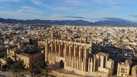 Palma-cathedral-by-drone-with-the-city-and-mountains-in-background