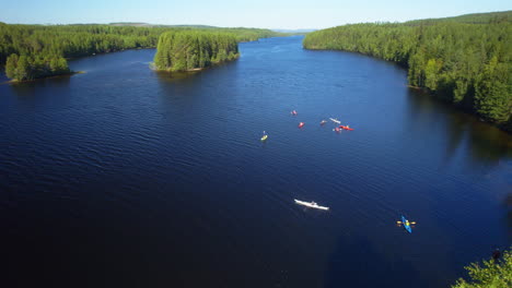 Drone-timelapse-of-a-group-of-people-kayaking-on-a-river-in-the-sun-during-summer