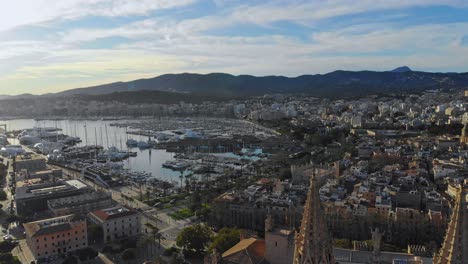 Static-drone-shot-of-Palma-cathedral-and-city-with-mountains-in-the-background