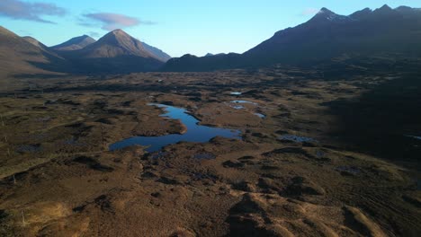 Reveal-shot-of-Loch-Caol-and-Scottish-moorland-with-Cuillin-mountains-at-Sligachan-on-the-Isle-of-Skye-Scotland