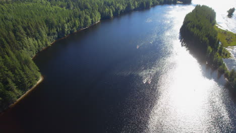 drone-shot-of-a-group-of-people-out-kayaking-on-a-river-in-the-forest