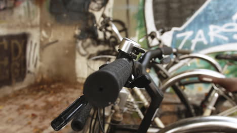 A-close-up-of-a-black-bicycle's-handlebars,-with-the-grips,-brakes,-and-frame-all-in-sharp-focus