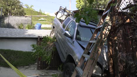 truck-crashes-off-rooftop-into-tree