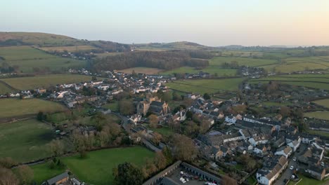 Aerial-drone-footage-of-the-Medieval-village-of-Cartmel-in-the-English-Lake-District-it-has-a-rich-heritage,-and-varied-list-of-activities-for-visitors-and-tourists