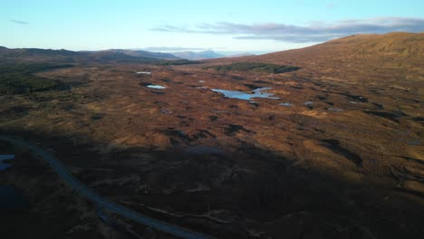 Flying-over-Scottish-winter-moorland-towards-Loch-Mor-na-Caiplaich-at-dawn-at-Sligachan-on-the-Isle-of-Skye-Scotland
