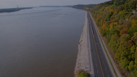 Aerial-descent-over-the-Great-River-Road-in-Illinois-in-Fall-as-a-white-van-approaches