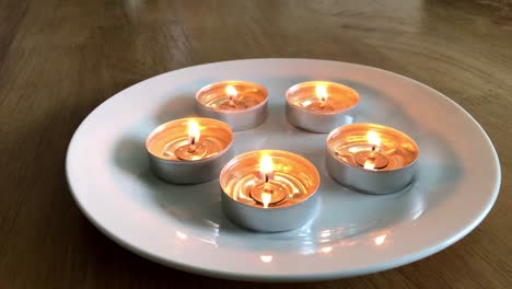 Candles-on-a-plate-with-dancing-flames
