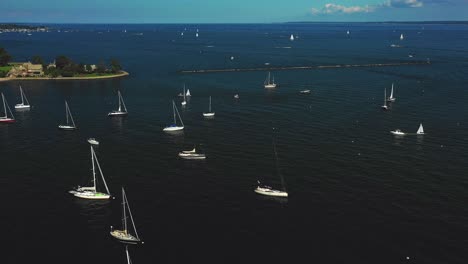 Drone-pan-across-a-harbor-full-of-yachts-and-boats-in-the-northeast-on-a-summer-day-in-4K