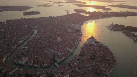 Higher-Altitude-Aerial-shot-of-Beautiful-Morning-light-reflections-over-Canal-Grande-in-Venice,-Italy