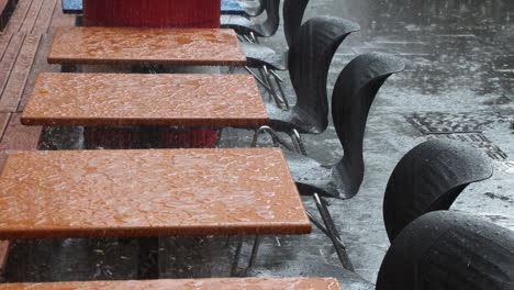 Starker-Regen-Auf-Einer-Caféterrasse,-Regentropfen-Auf-Dem-Tisch