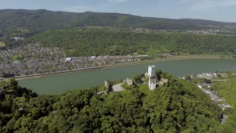Drone-flies-parallel-to-the-river-revealing-two-castles-on-the-mountains