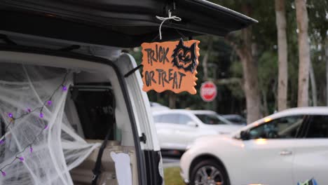 Sign-hanging-from-a-cars-trunk-saying-Trick-or-Treat