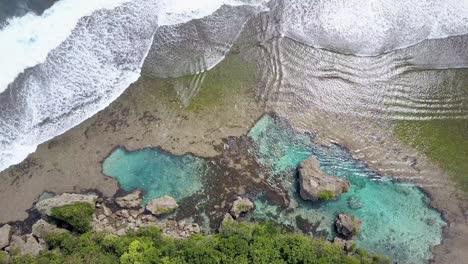 Aerial-view-of-ocean-waves-at-rock-pool-Magpupungko-in-Siargao,-the-Philippines